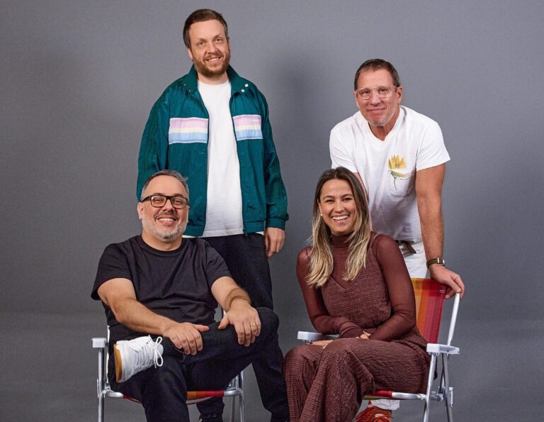 Na foto, da esquerda pra direita, em pé: Pedro Burneiko (Principal Designer) e Marcus Sulzbacher (CCO e Cofundador); sentados: João Gabriel Fernandes (Chief Strategy Officer) e Caroline Rua (Diretora de Negócios e Projetos).